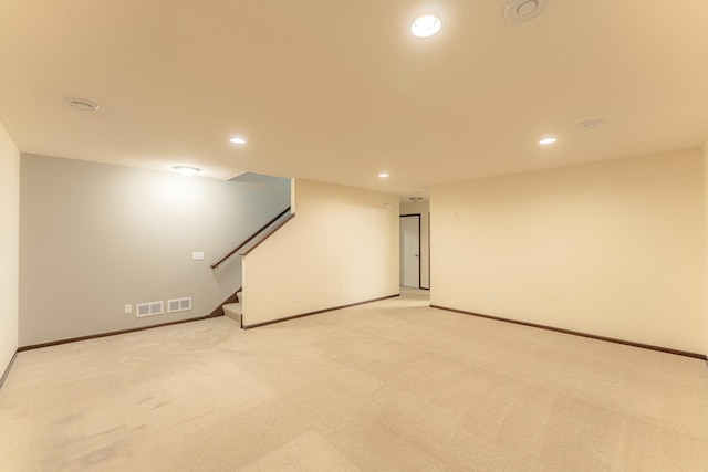 basement featuring light carpet