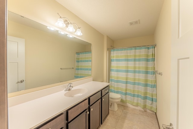 bathroom featuring vanity, toilet, a shower with curtain, and tile patterned flooring