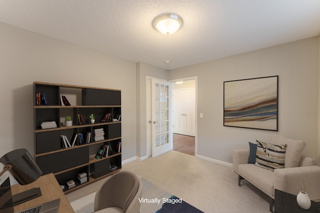 living area with a textured ceiling and carpet