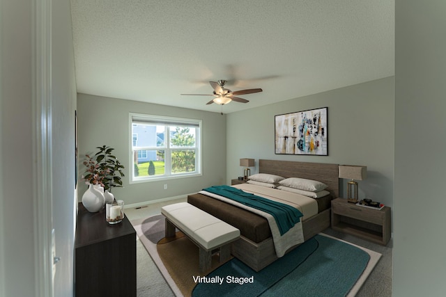 carpeted bedroom with a textured ceiling and ceiling fan