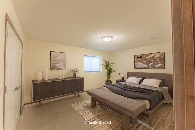 carpeted bedroom with a textured ceiling