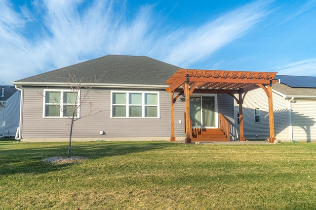 rear view of property with entry steps, a yard, roof with shingles, and a pergola