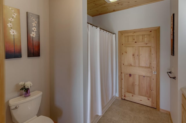 bathroom featuring curtained shower, toilet, tile patterned floors, and wood ceiling