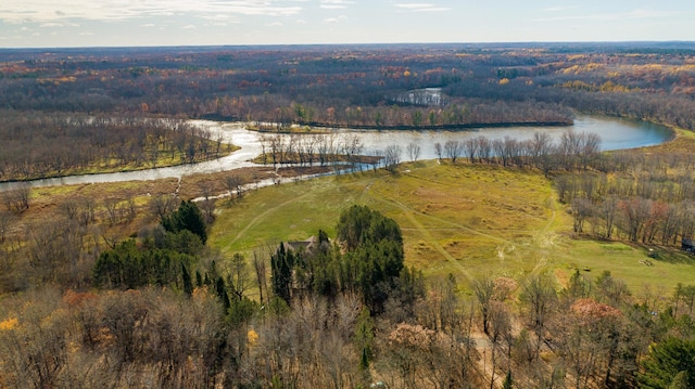 drone / aerial view featuring a water view and a forest view
