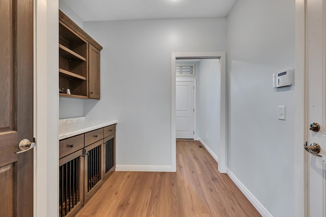 bar with light hardwood / wood-style flooring