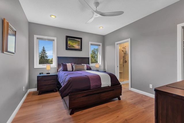 bedroom with ceiling fan, ensuite bath, and light hardwood / wood-style flooring