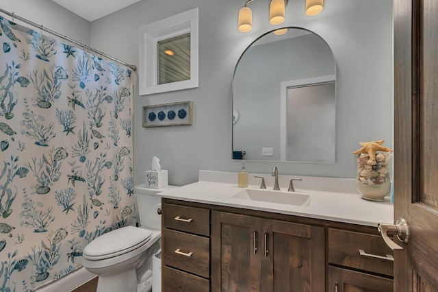 bathroom featuring vanity, toilet, and a shower with shower curtain