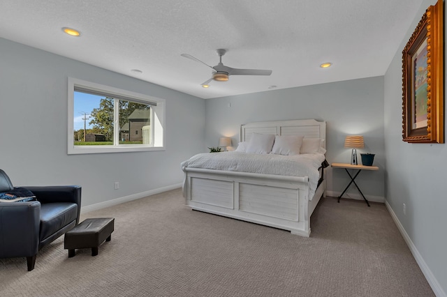 carpeted bedroom with a textured ceiling and ceiling fan