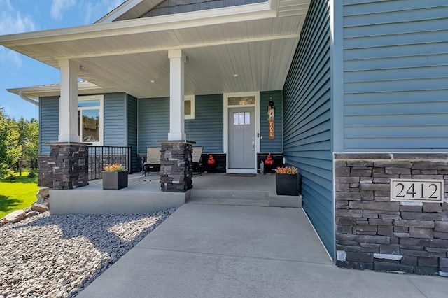 doorway to property featuring covered porch