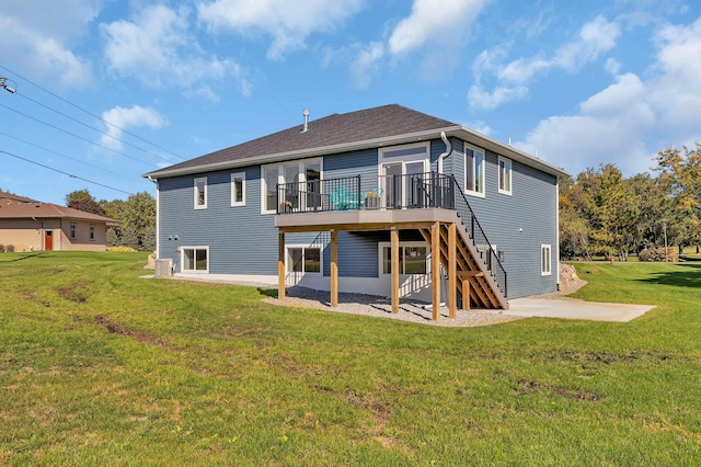 back of house featuring a patio, a yard, and a wooden deck