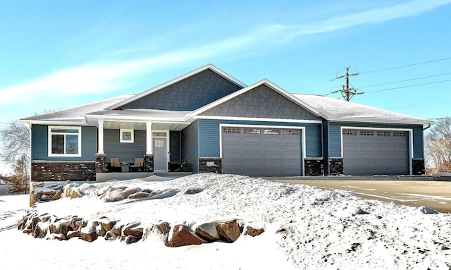 craftsman-style home featuring covered porch and a garage