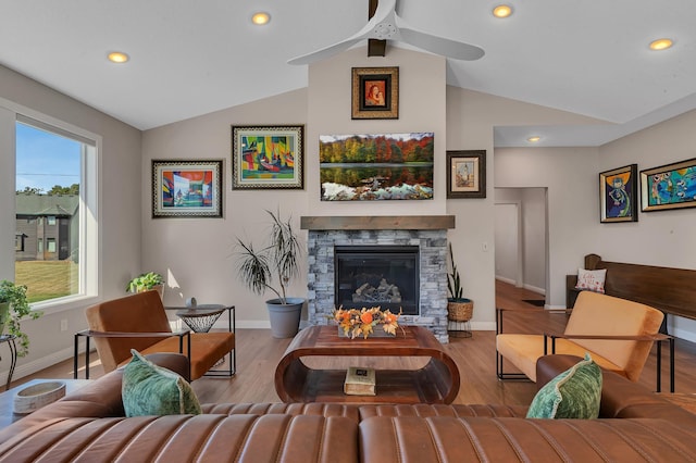 sitting room with hardwood / wood-style flooring, ceiling fan, lofted ceiling, and a fireplace