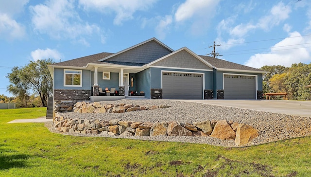 craftsman-style home with a garage and a front lawn