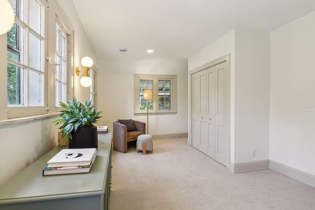 living area with light colored carpet