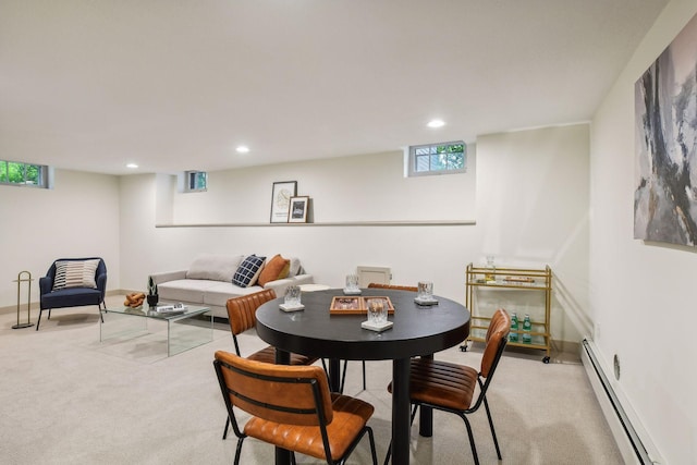 carpeted dining area featuring a baseboard heating unit