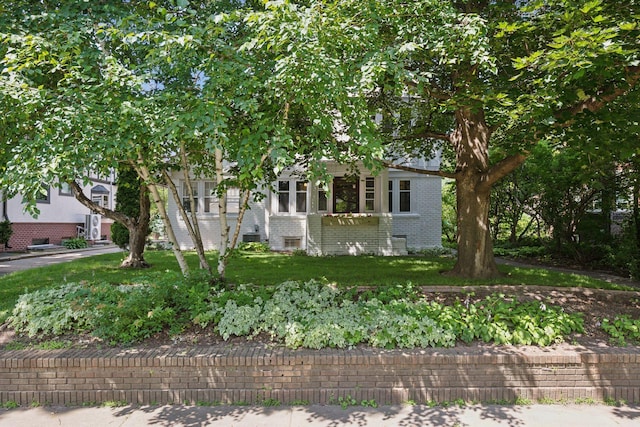 obstructed view of property featuring a front yard