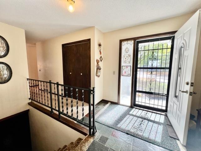 entryway with a textured ceiling