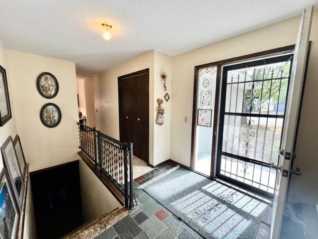 entryway featuring a textured ceiling