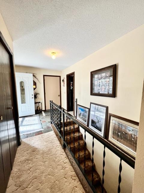 hallway featuring a textured ceiling