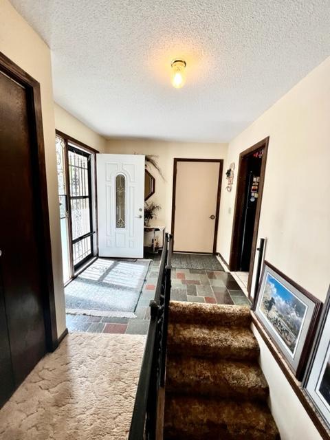 entryway with a textured ceiling