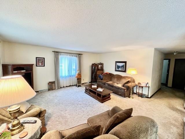 living room featuring light carpet and a textured ceiling