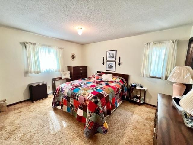 carpeted bedroom featuring a textured ceiling