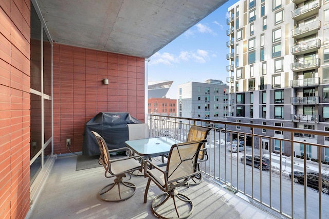 balcony with area for grilling and a city view