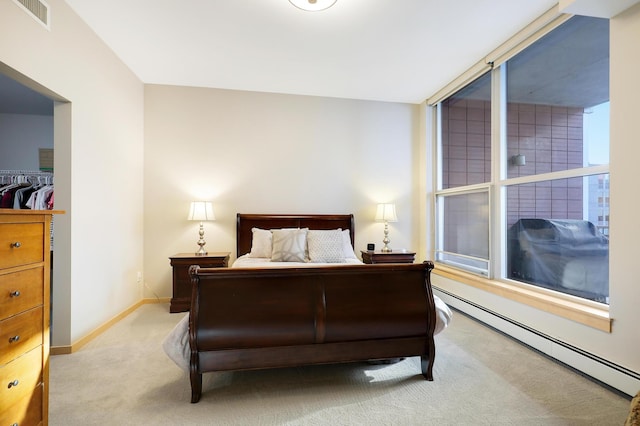 bedroom featuring a baseboard radiator, visible vents, light carpet, and multiple windows