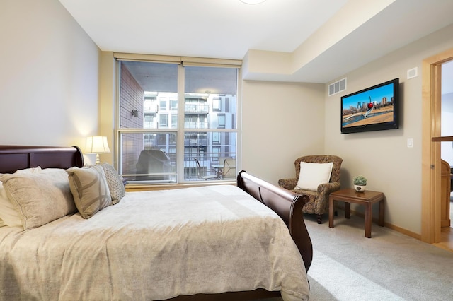 carpeted bedroom with floor to ceiling windows, visible vents, and baseboards