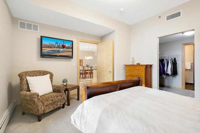 carpeted bedroom featuring baseboard heating, a closet, visible vents, and an inviting chandelier