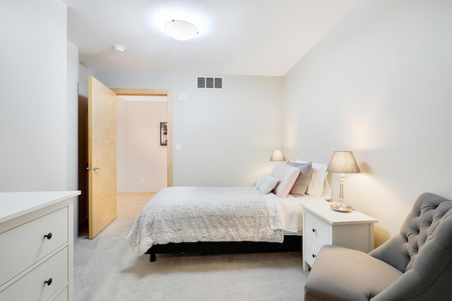 bedroom with visible vents and light colored carpet