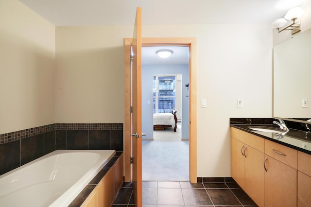 ensuite bathroom with a garden tub, tile patterned flooring, connected bathroom, and vanity