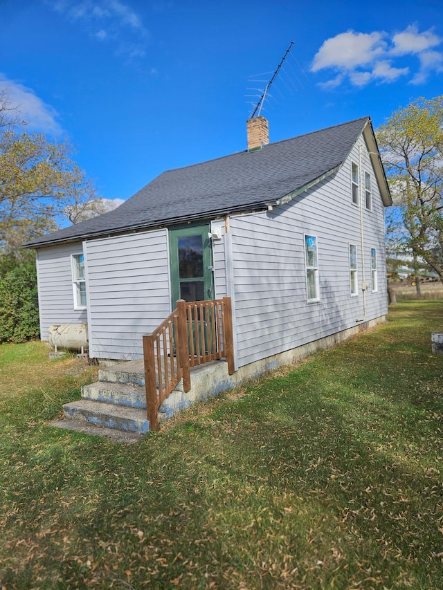 back of property featuring a lawn