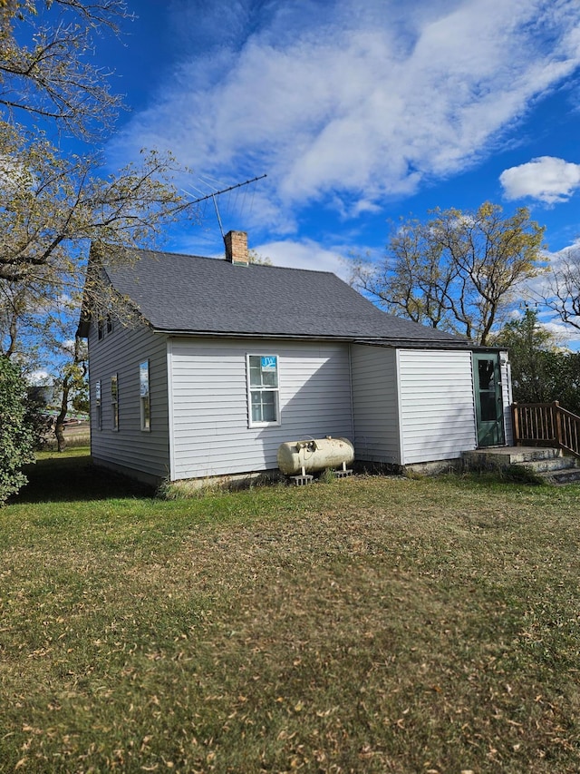 back of property featuring a lawn