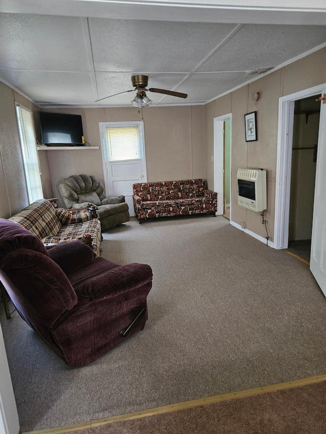 carpeted living room featuring heating unit and ceiling fan