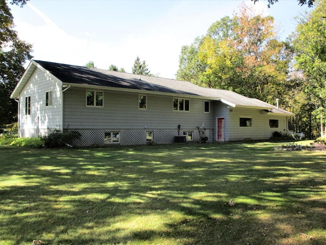 back of property with a lawn