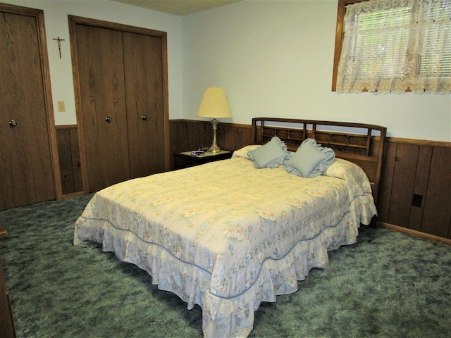 bedroom featuring dark carpet, a closet, and wood walls