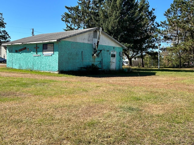 view of property exterior with a yard