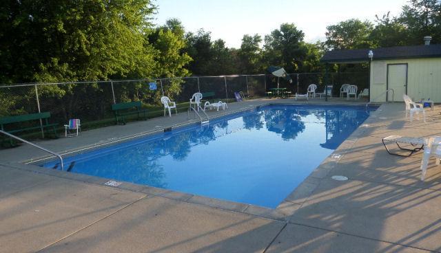 pool featuring fence and a patio