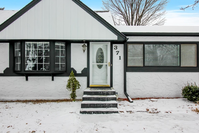 view of snow covered property entrance