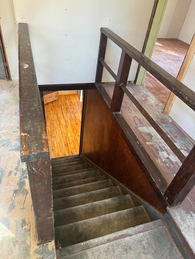 stairs featuring hardwood / wood-style flooring