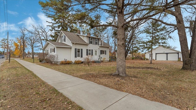 view of front of property featuring an outdoor structure, a front lawn, and a garage