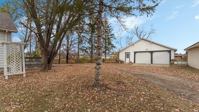 view of yard featuring an outbuilding and a garage