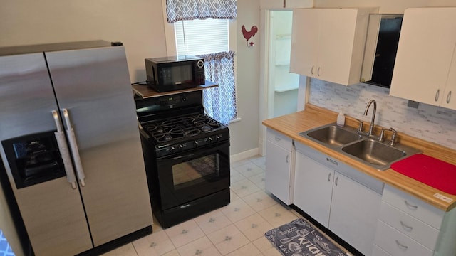 kitchen featuring white cabinets, black appliances, sink, and tasteful backsplash