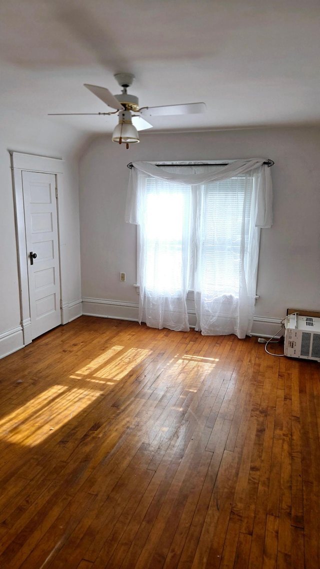 empty room with hardwood / wood-style flooring and ceiling fan