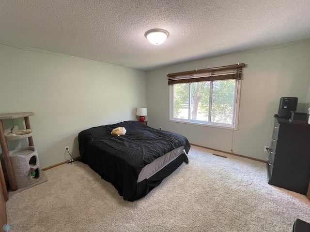 carpeted bedroom with a textured ceiling