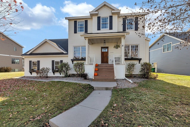 view of front of property featuring a front yard and covered porch