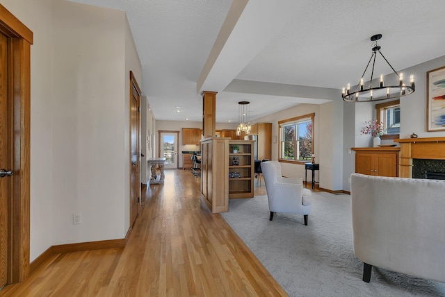 2008 11th St N, Sartell, MN 56377 - living room featuring a chandelier, plenty of natural light, baseboards, and light wood-style floors