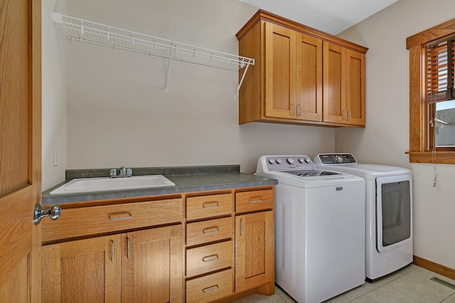 2008 11th St N, Sartell, MN 56377 - laundry room featuring cabinet space, washer and clothes dryer, light tile patterned flooring, and baseboards