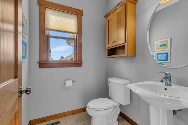 2008 11th St N, Sartell, MN 56377 - bathroom featuring baseboards, toilet, tile patterned flooring, and a sink